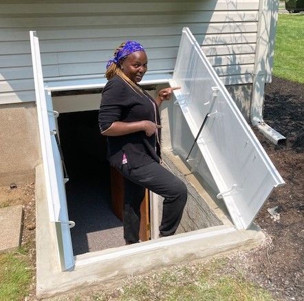 A woman is standing in a basement with the door open