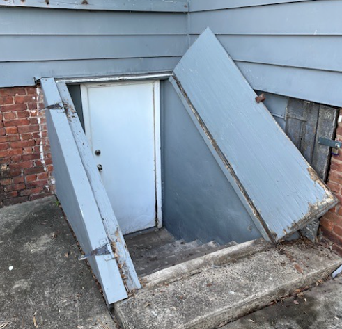 A brick is laying on the ground next to a staircase