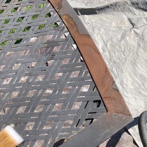 A brush is sitting on top of a wicker chair