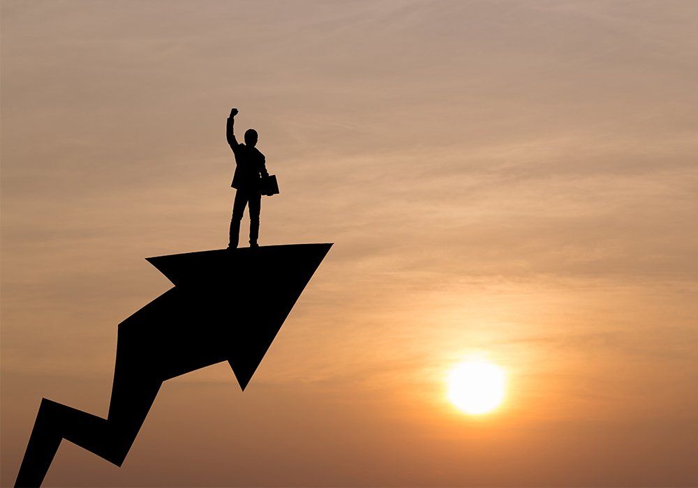 Silhouette of business man are celebrating success on graph up, sky and sun light background. Business, successful, achievement and goal concept.