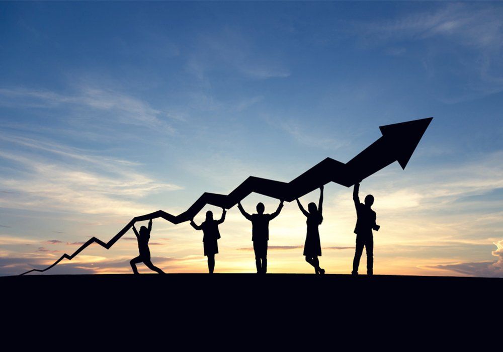 Silhouette of business people and graph at sky and sunset background. Cooperate, success, teamwork and goal concept.