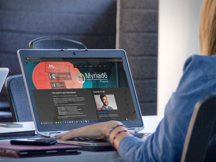 Person looking at a radio website provided by Broadcast Radio.