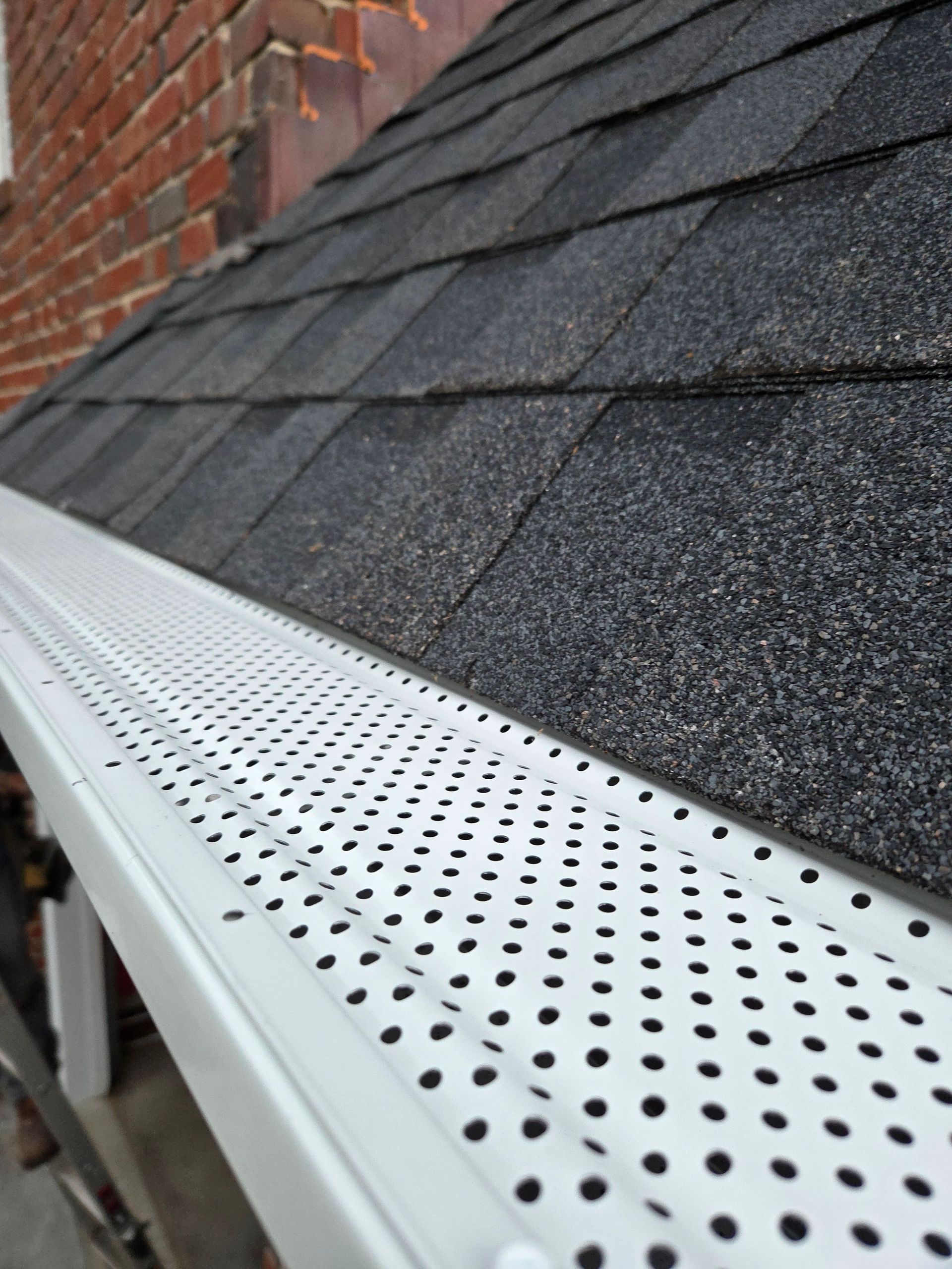 A skilled window cleaning team working diligently to clear grime and dirt from the windows of a tall urban skyscraper.