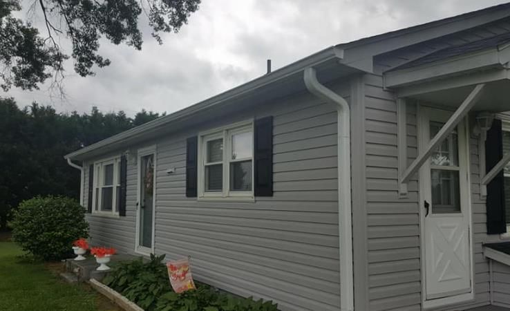 A skilled window cleaning team working diligently to clear grime and dirt from the windows of a tall urban skyscraper.