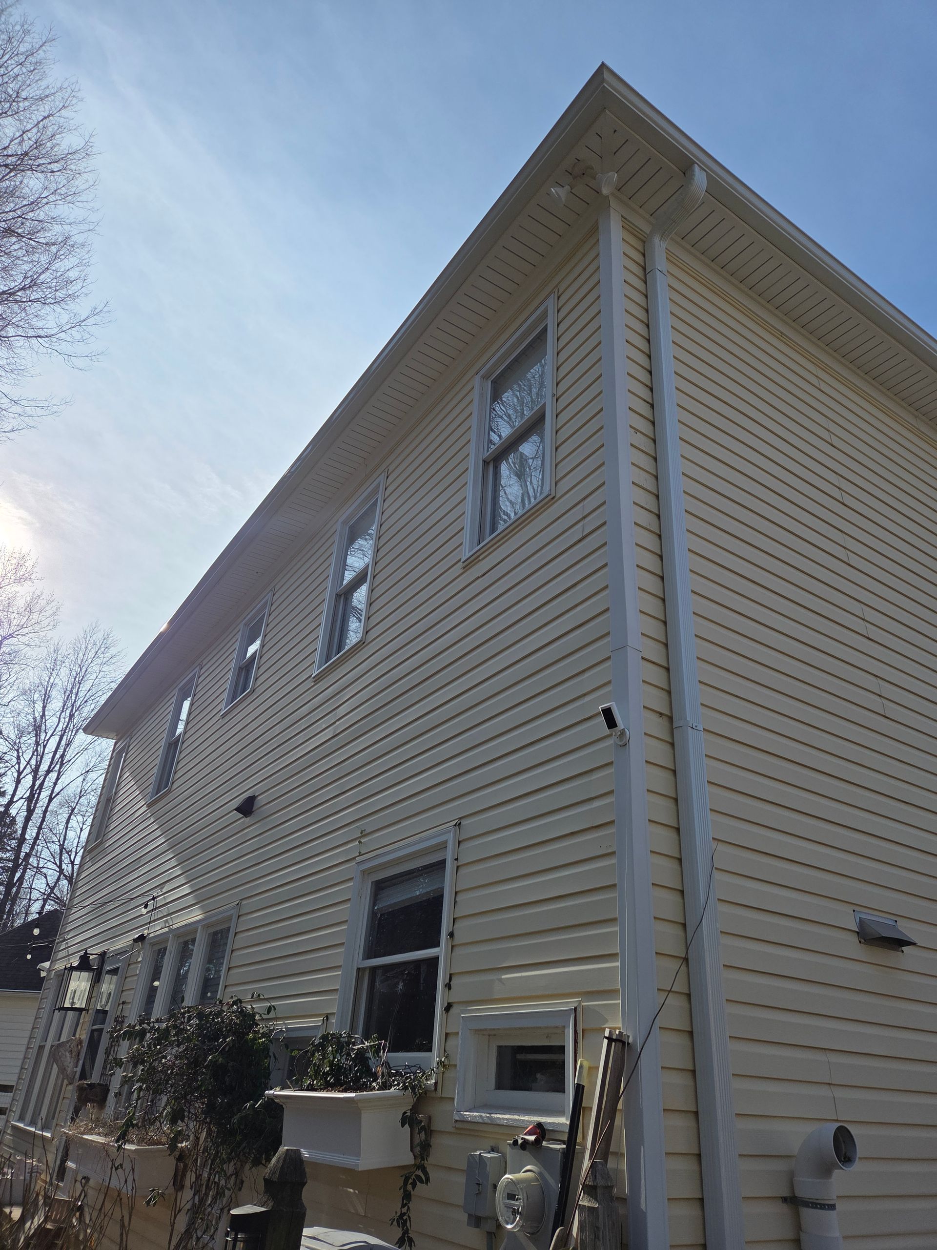 A skilled window cleaning team working diligently to clear grime and dirt from the windows of a tall urban skyscraper.