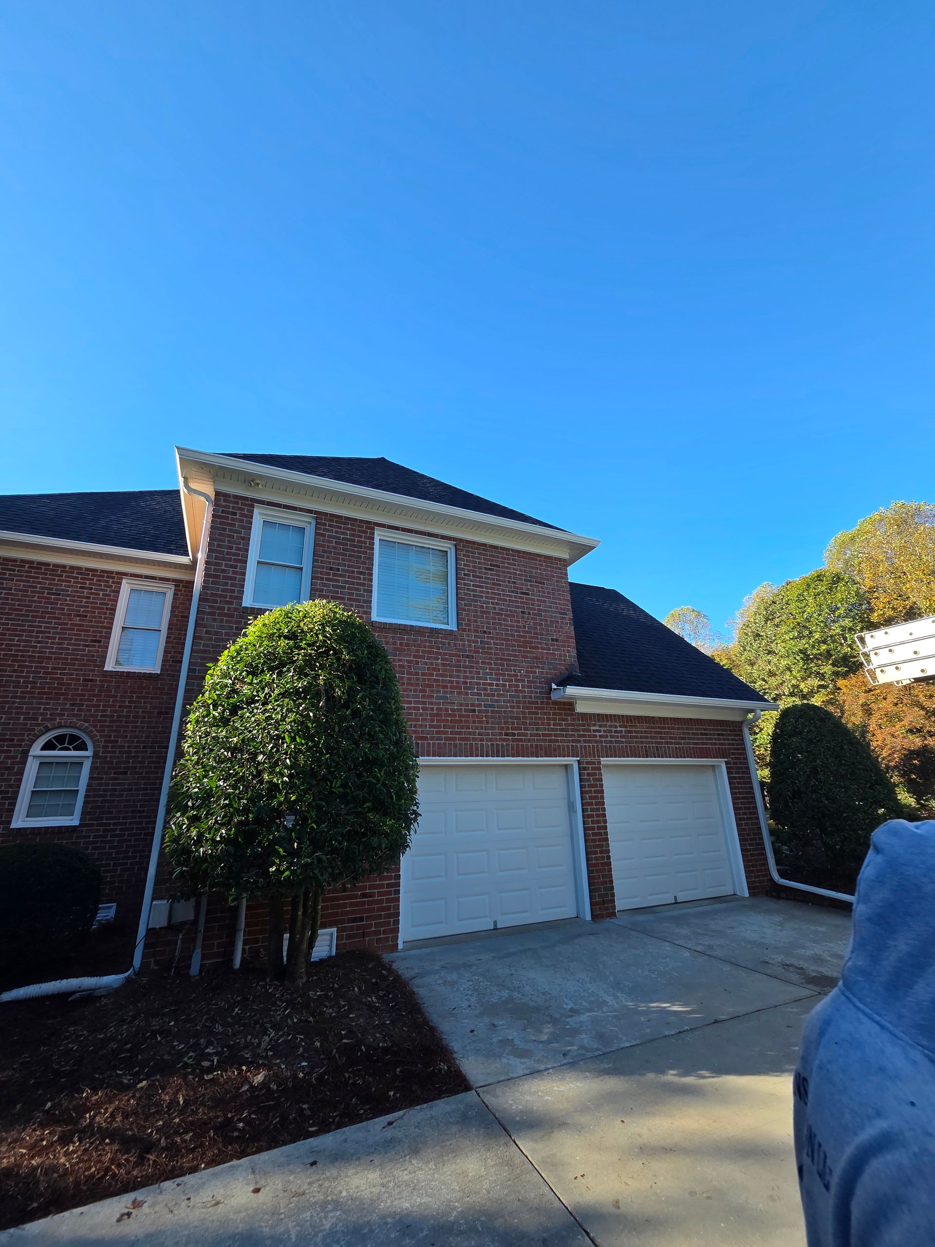 A skilled window cleaning team working diligently to clear grime and dirt from the windows of a tall urban skyscraper.