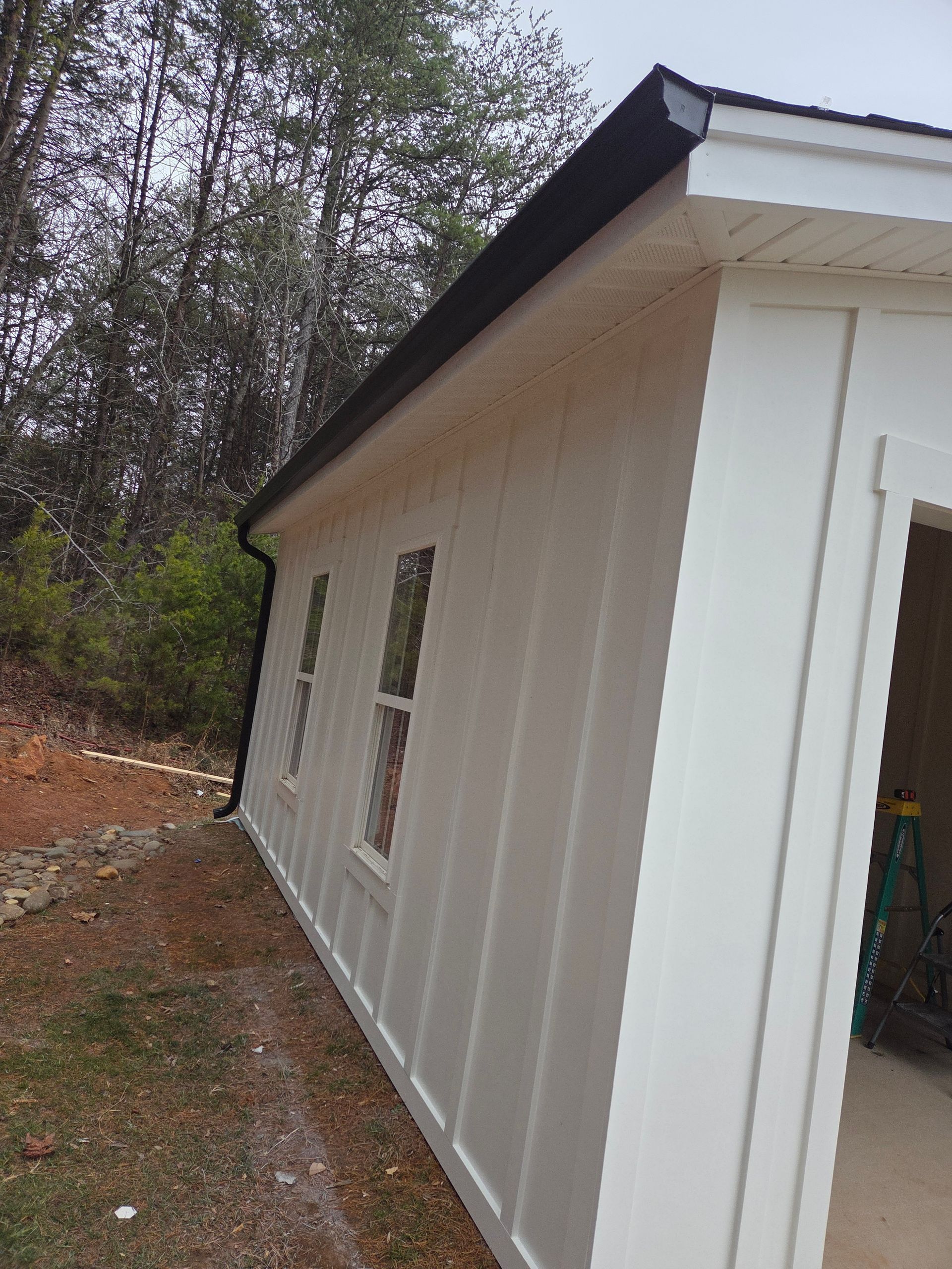 A skilled window cleaning team working diligently to clear grime and dirt from the windows of a tall urban skyscraper.