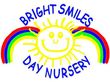 Bright smiles day nursery logo with a smiling sun and rainbows