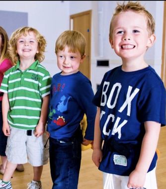 A boy wearing a blue shirt that says box ck