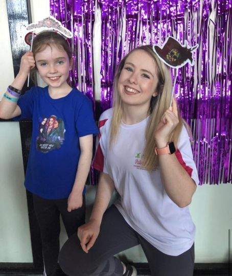 A woman and a little girl are posing for a picture
