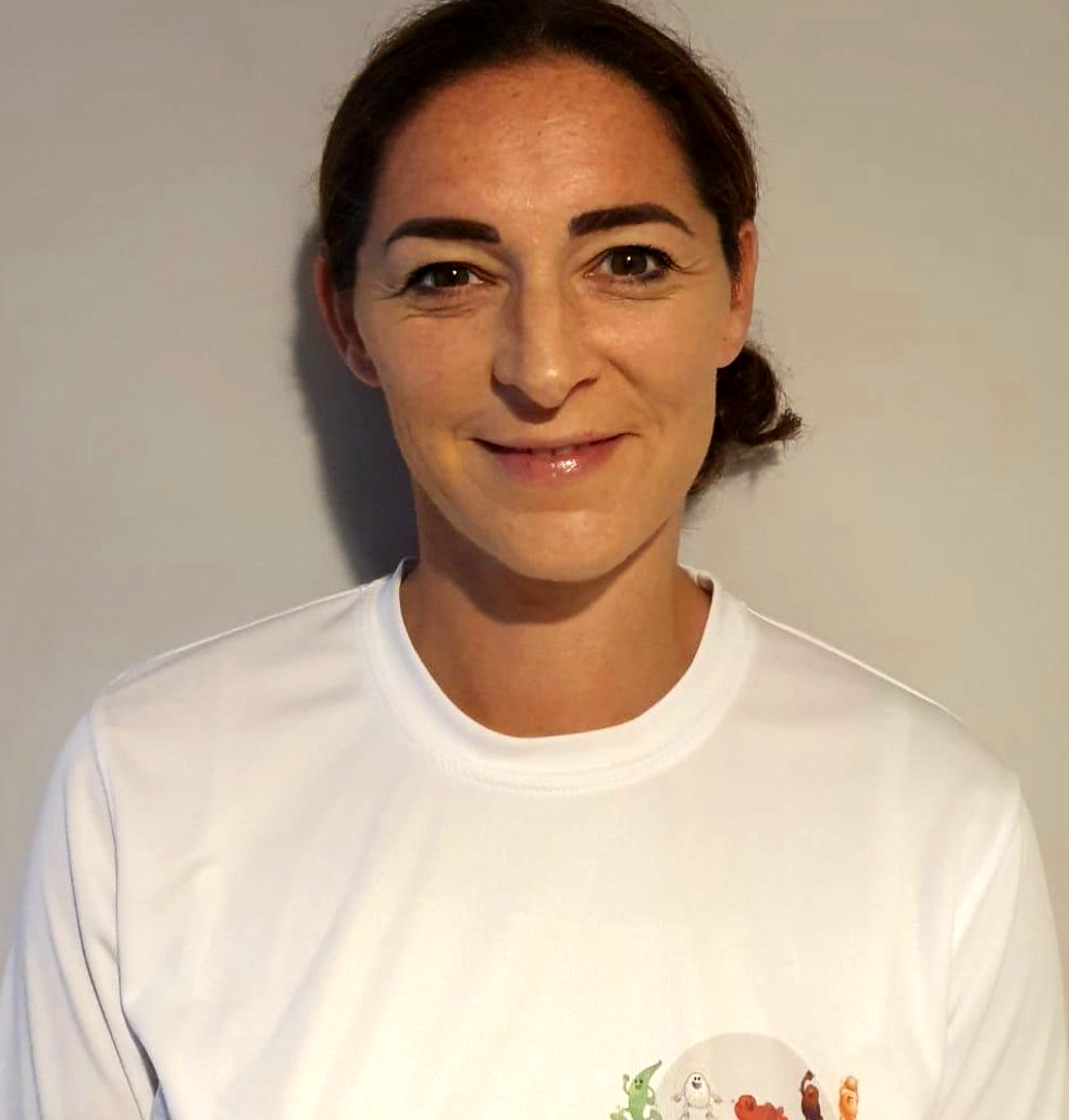 A woman wearing a white shirt with a picture of people on it