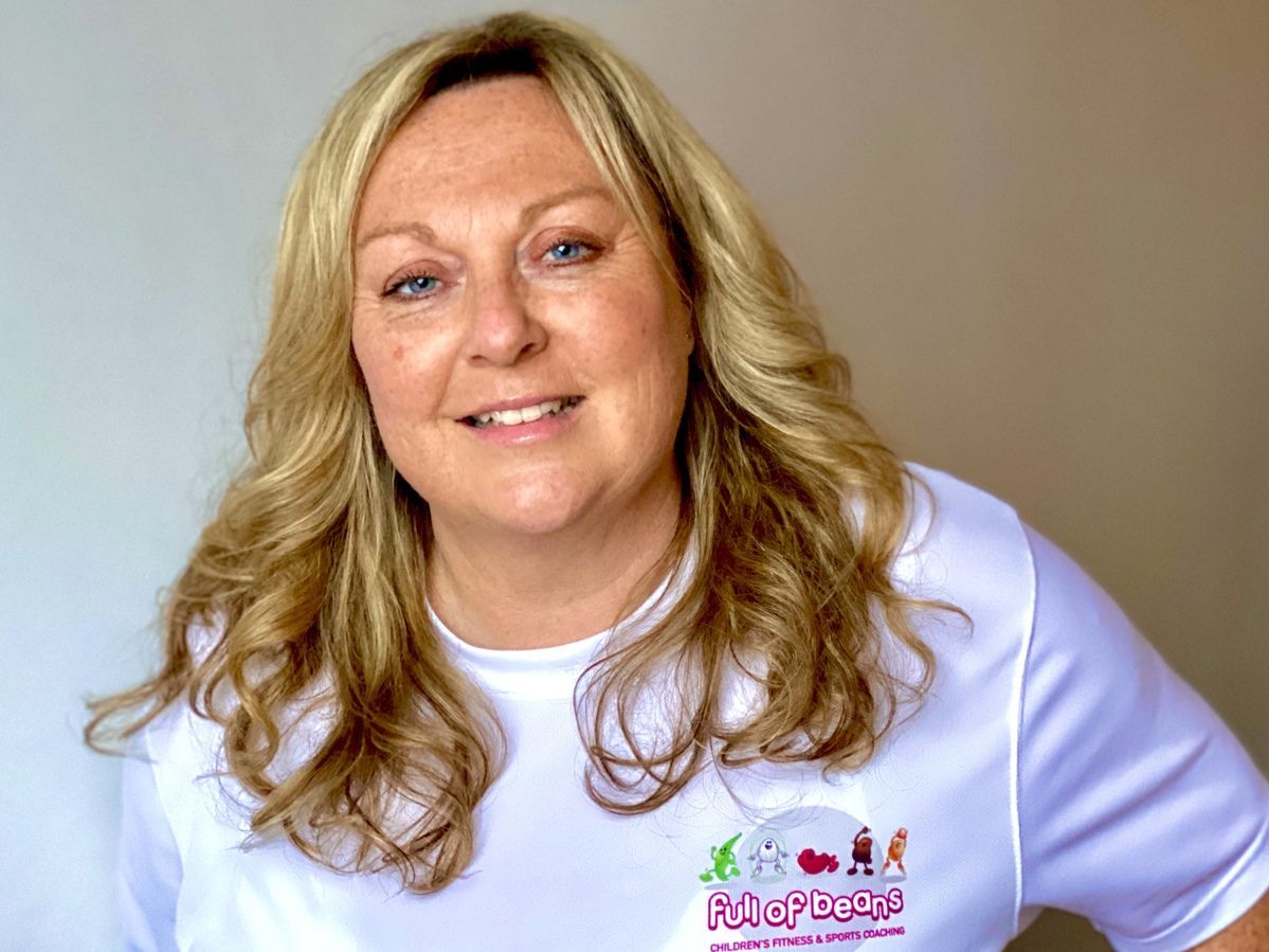 A woman wearing a white shirt with a logo on it