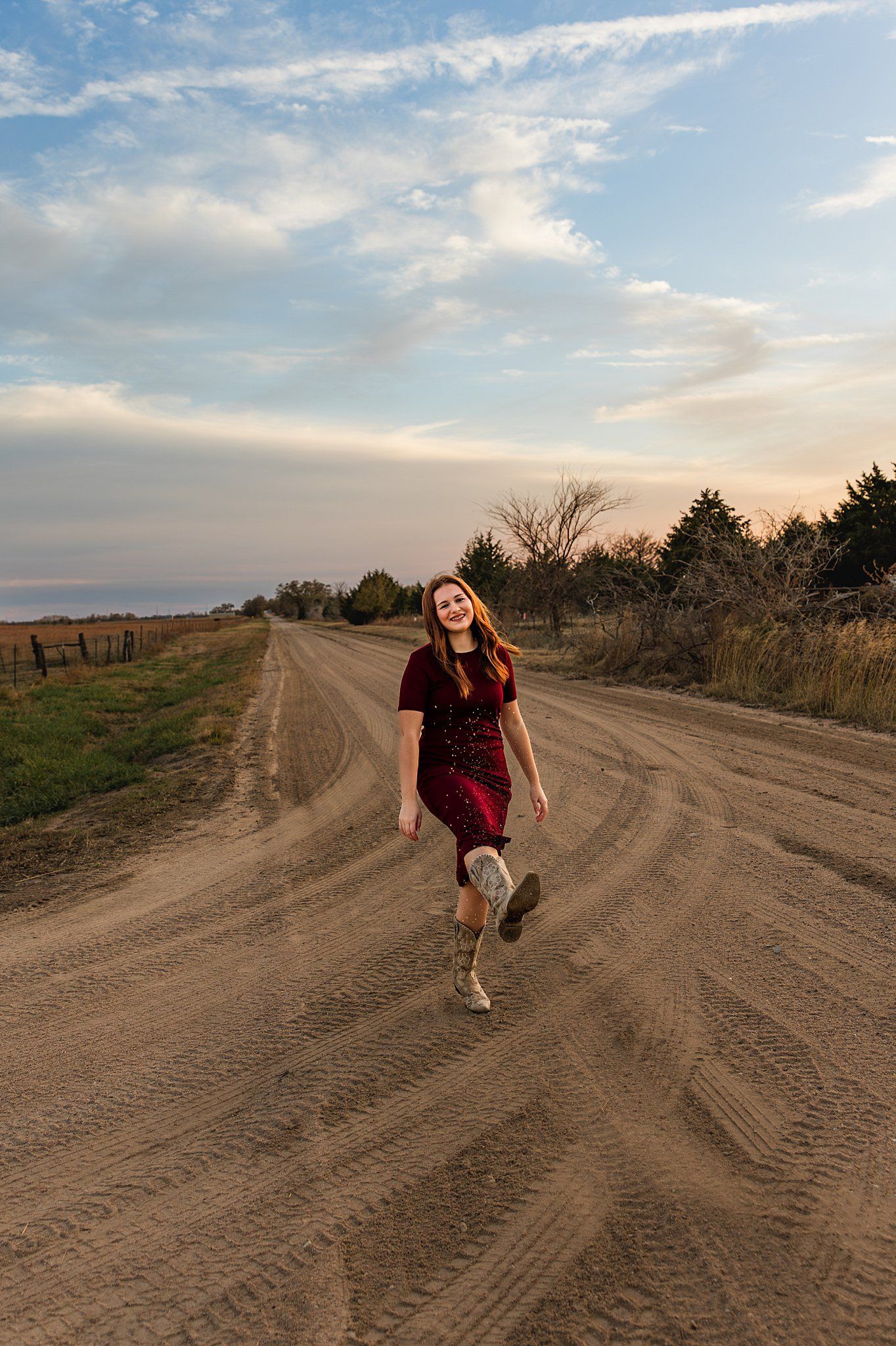 High‑school senior running down dirt road Burrton KS photographer Sara McMillian
