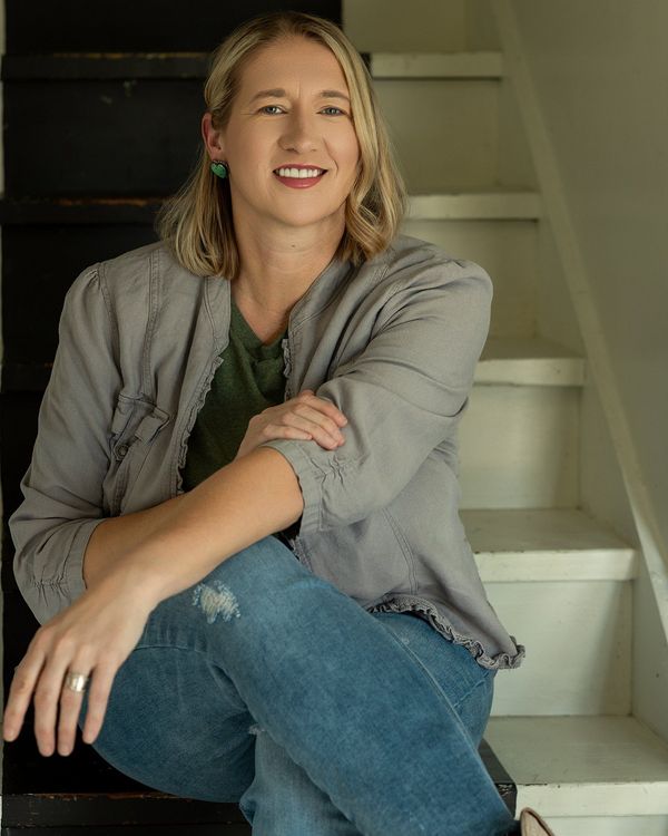 Professional headshot of a woman in a blazer, captured by Sara McMillian for personal branding in Yoder, KS