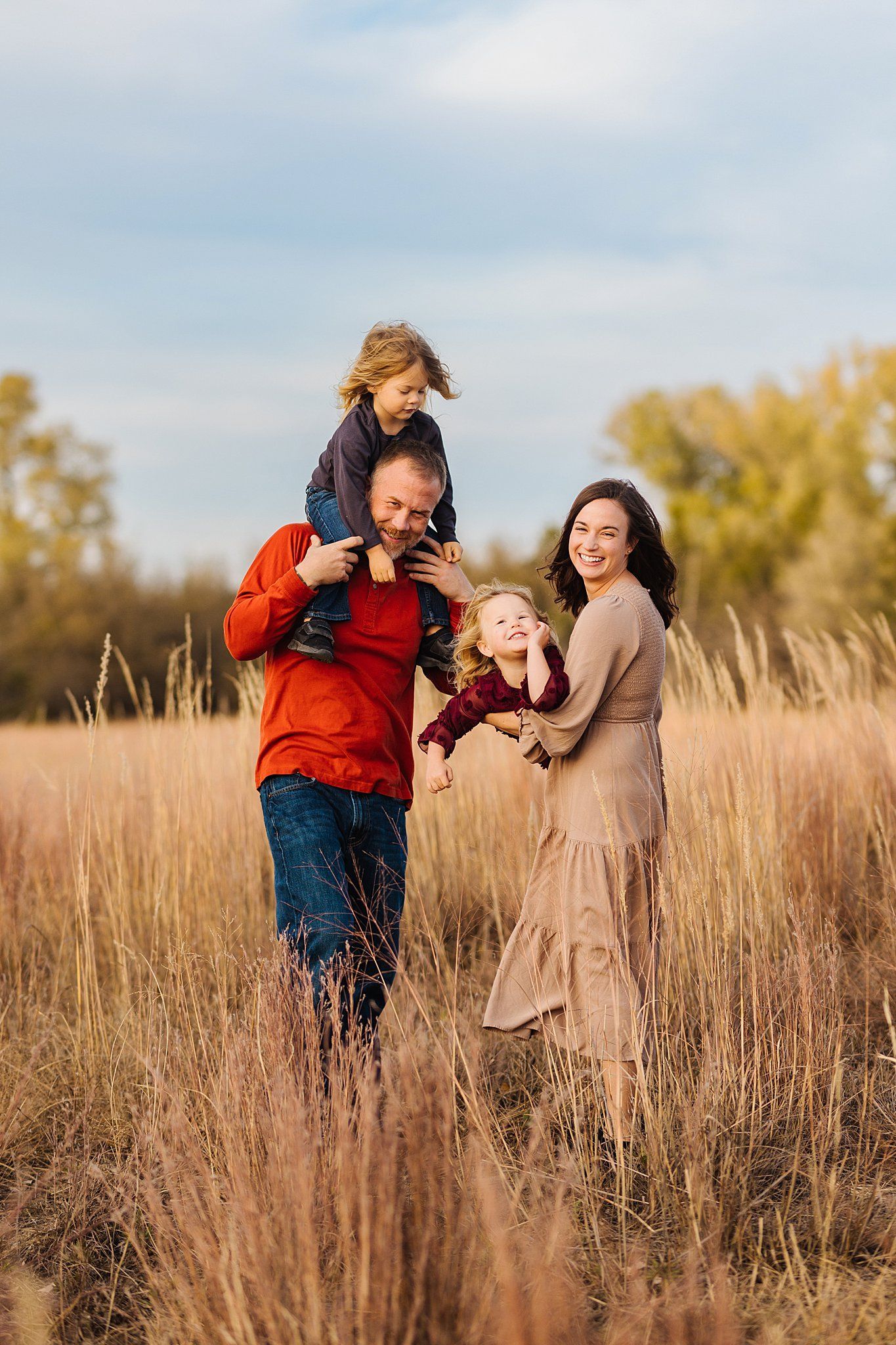 Playful unposed family laughing  in the golden hour light during farm mini session Burrton KS Sara McMillian Photography
