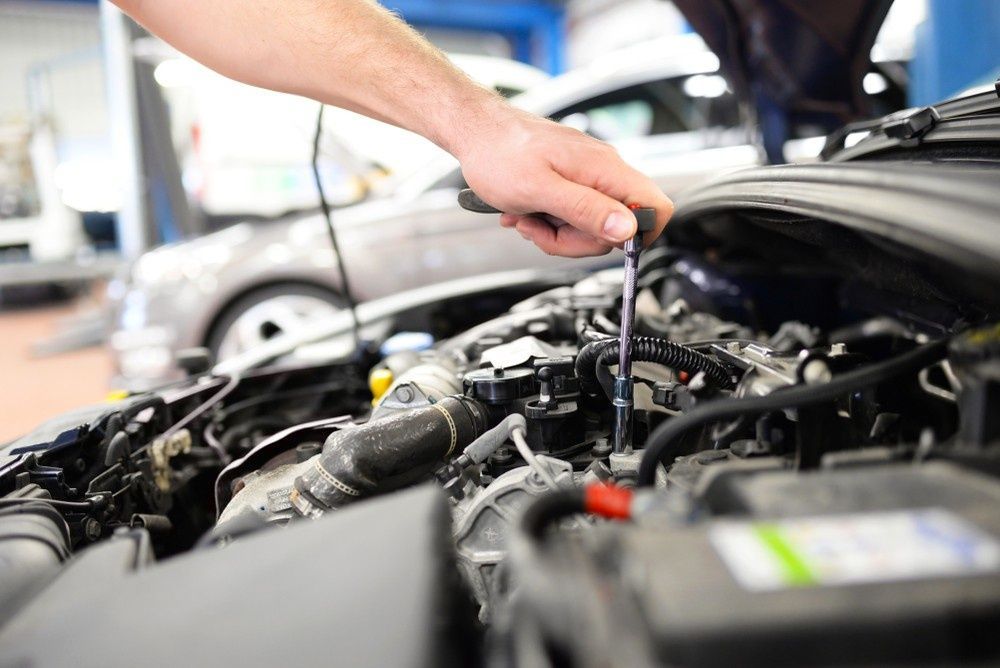 A Mechanic Working on A Car Engine — Woden Automotive Services in Woden, ACT