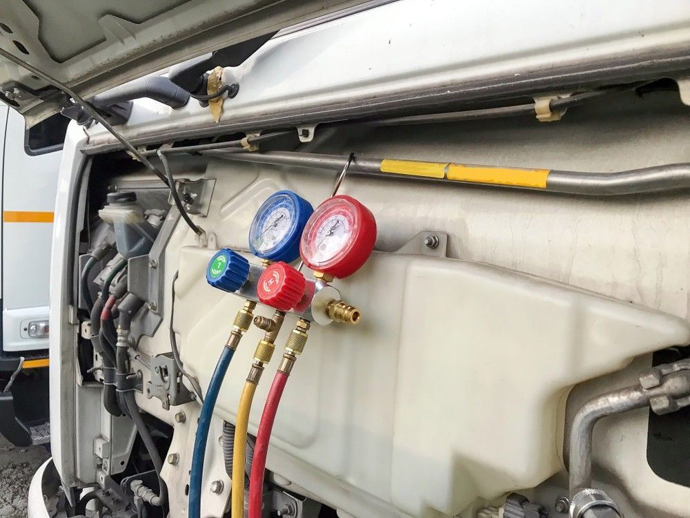 An Air Conditioning Gauges Connected to A Vehicle Coolant Tank — Woden Automotive Services in Phillip, ACT