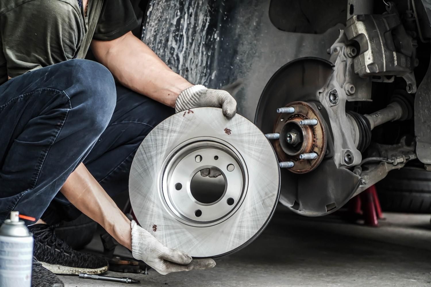 A Mechanic Replacing a Car Brake Rotor — Woden Automotive Services in Phillip, ACT
