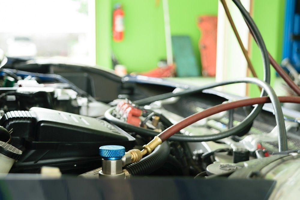 A Car Engine Bay with Ac Service Equipment Attached — Woden Automotive Services in Curtin, ACT