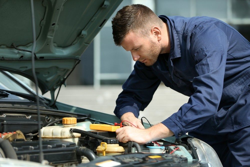 A Mechanic Working on A Car Engine — Woden Automotive Services in Curtin, ACT