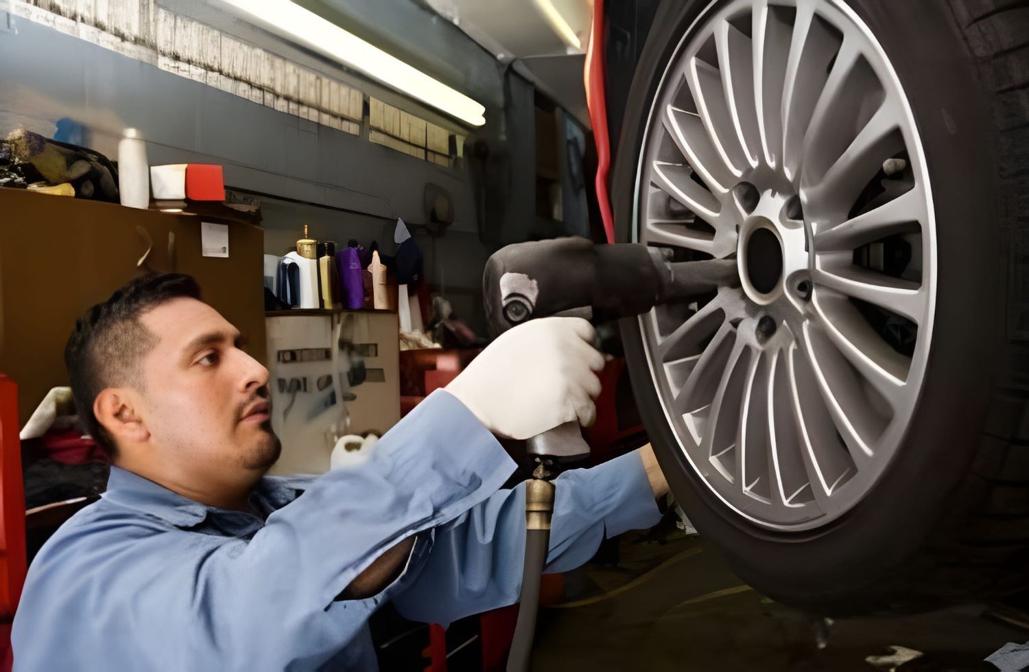 A Mechanic Using an Impact Wrench on A Car — Woden Automotive Services in Phillip, ACT