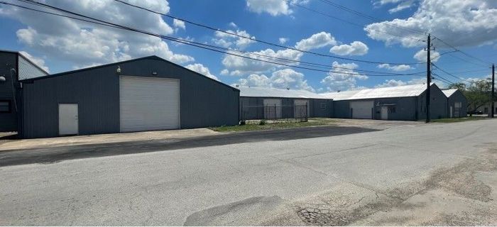 A row of warehouses sitting next to each other on the side of a road.