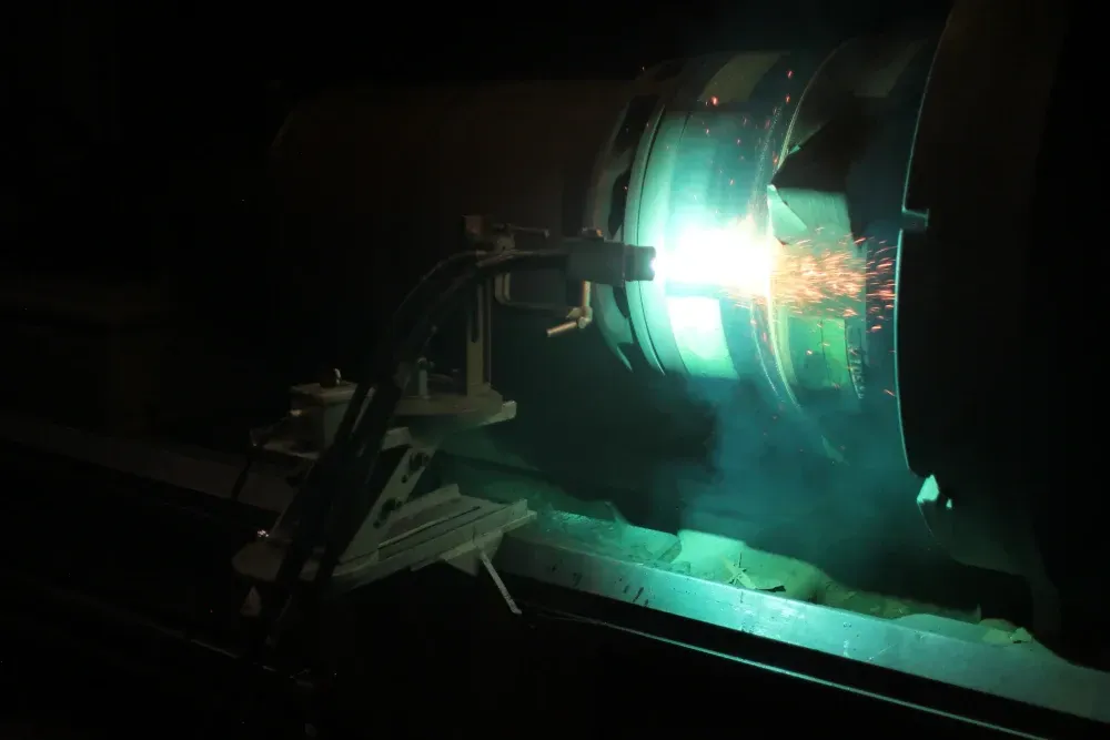 A side view of a part being coated using the Arc Spray process.