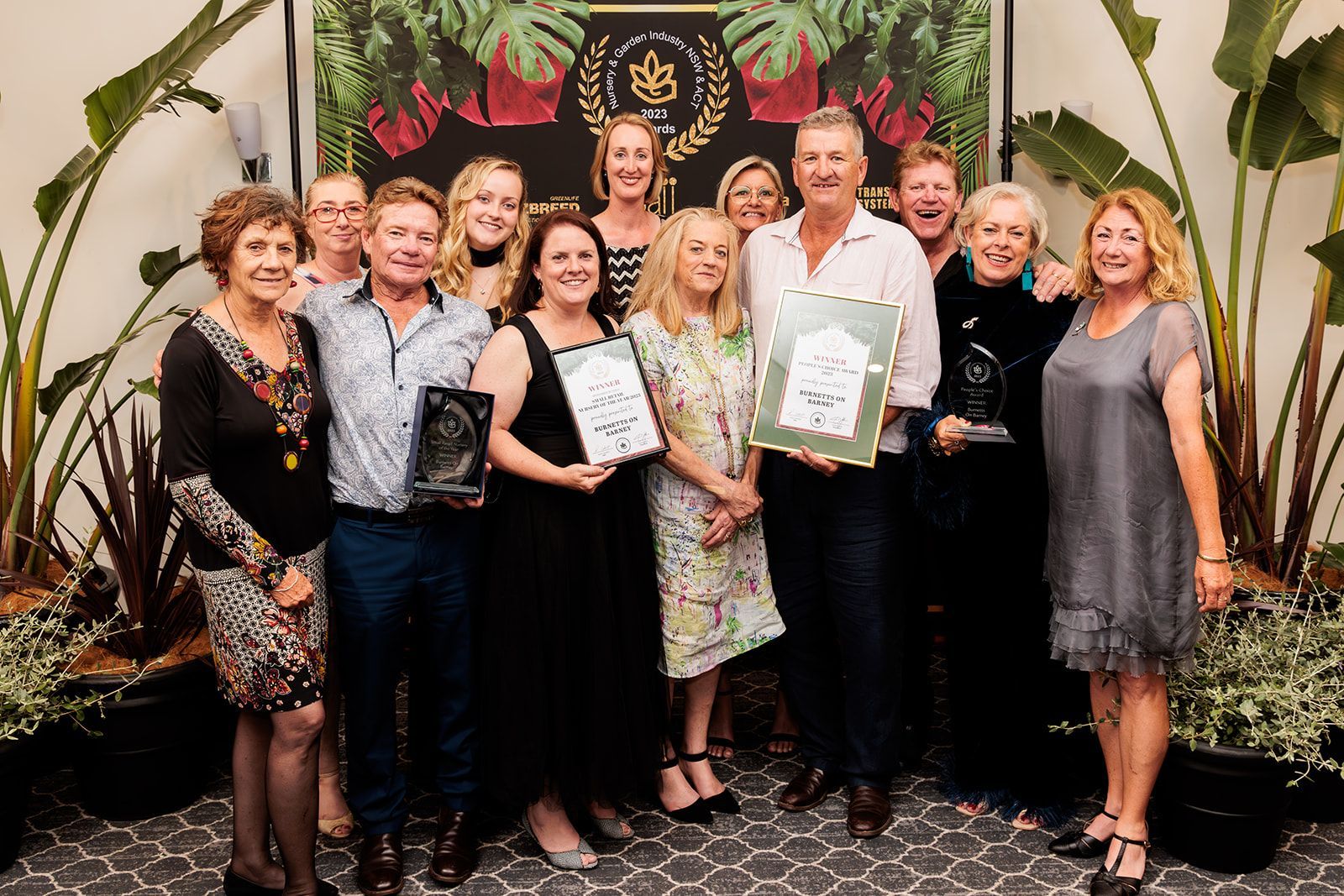 A Group Of People Are Posing For A Picture While Holding Awards — Burnetts On Barney in Kiama, NSW