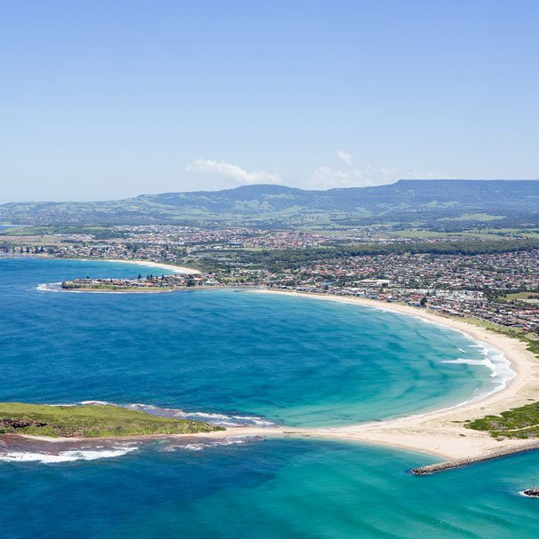 An Aerial View Of A Sandy Beach Surrounded By Turquoise Water — Burnetts On Barney in Warilla, NSW