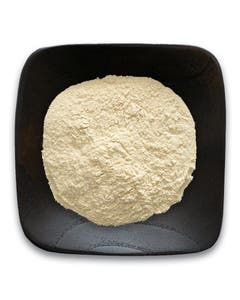 A black plate topped with a pile of white powder.