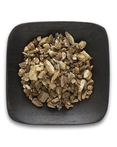 A black plate topped with a pile of dried mushrooms on a white background.