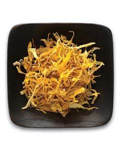 A black square plate topped with a pile of dried vegetables.