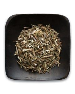 A black bowl filled with dried herbs on a white background.