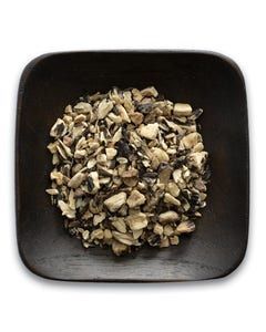A wooden bowl filled with chopped mushrooms on a white background.