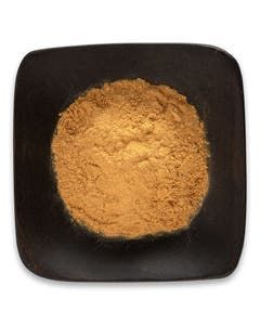 A black square bowl filled with brown powder on a white background.