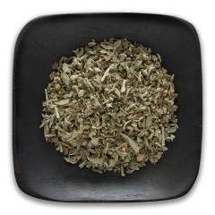 A black plate topped with dried herbs on a white background.