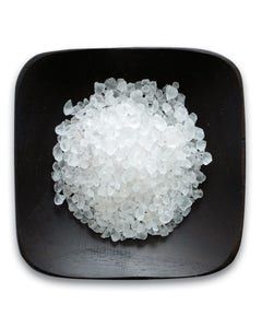 A black plate topped with a pile of white crystals.