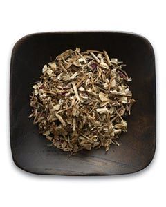 A wooden bowl filled with dried herbs on a white background.