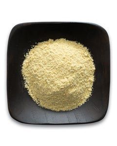 A black bowl filled with yellow powder on a white background.