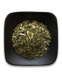 A black bowl filled with dried herbs on a white background.
