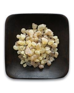 A black square plate topped with a pile of white rocks.