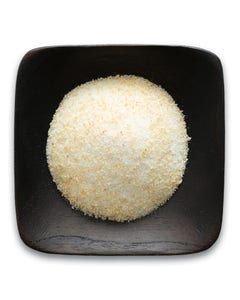 A black square plate topped with a ball of rice.