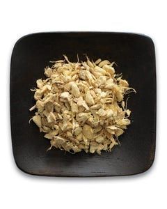 A black square plate topped with chopped ginger on a white background.