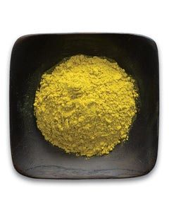 A black bowl filled with yellow powder on a white background.