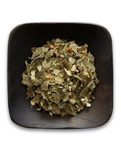 A wooden bowl filled with dried herbs on a white background.