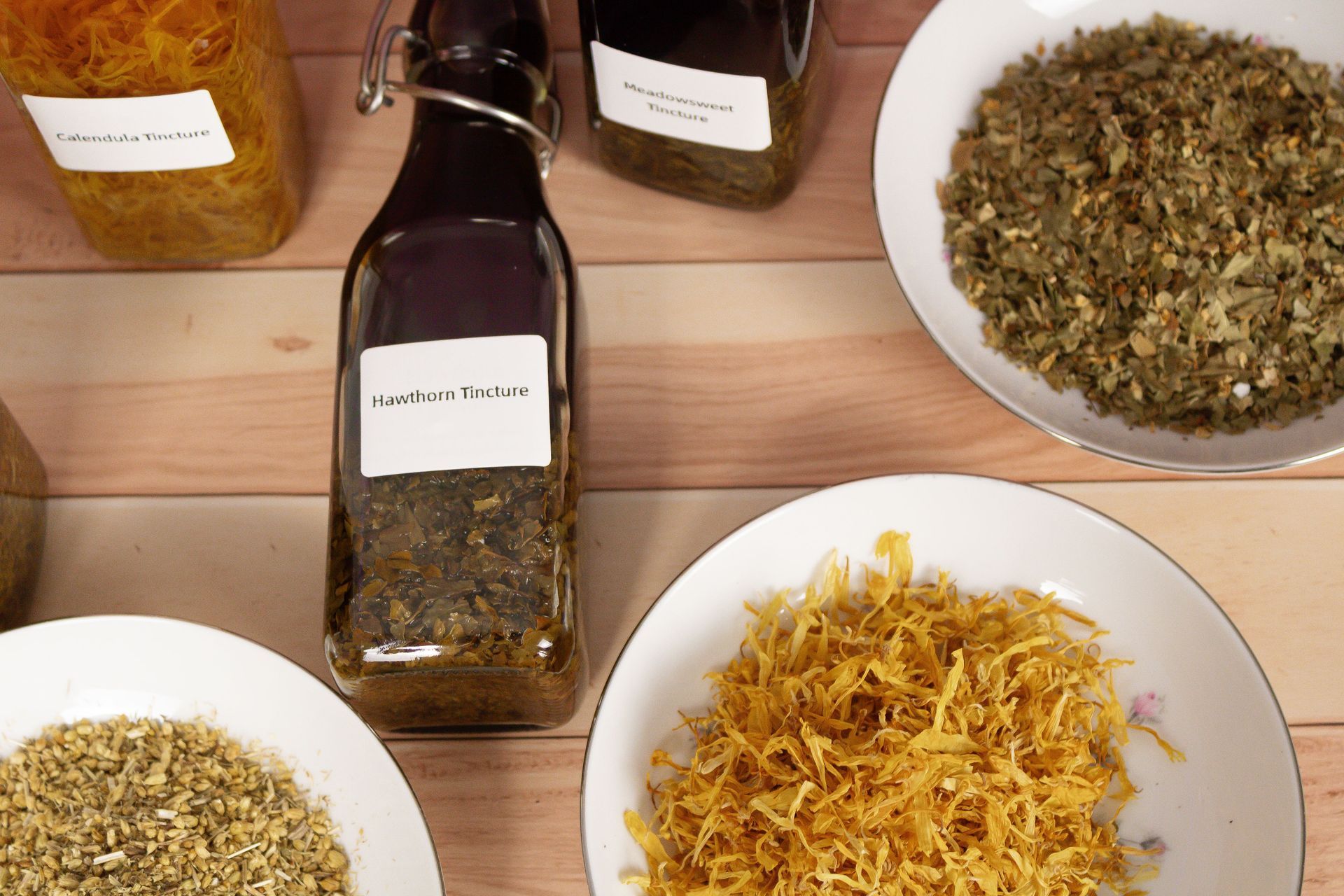Bottles and bowls of spices on a wooden table