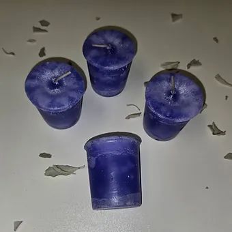 A group of purple candles sitting on top of a white table.