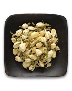 A black bowl filled with dried jasmine flowers on a white background.