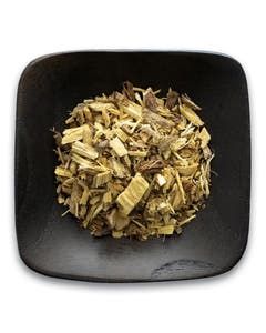A black bowl filled with wood chips on a white background.