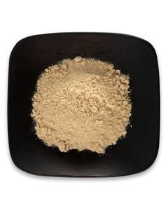 A black plate topped with a pile of powder on a white background.